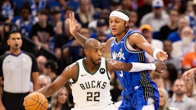 Milwaukee Bucks forward Khris Middleton (22) pushes past Orlando Magic forward Paolo Banchero (5)